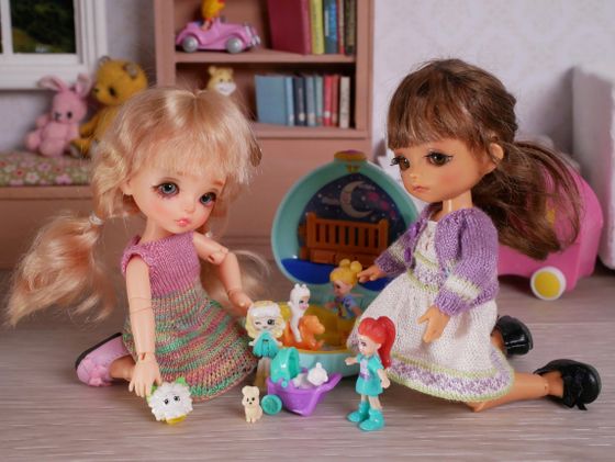 Sandy and Annie playing with dollies